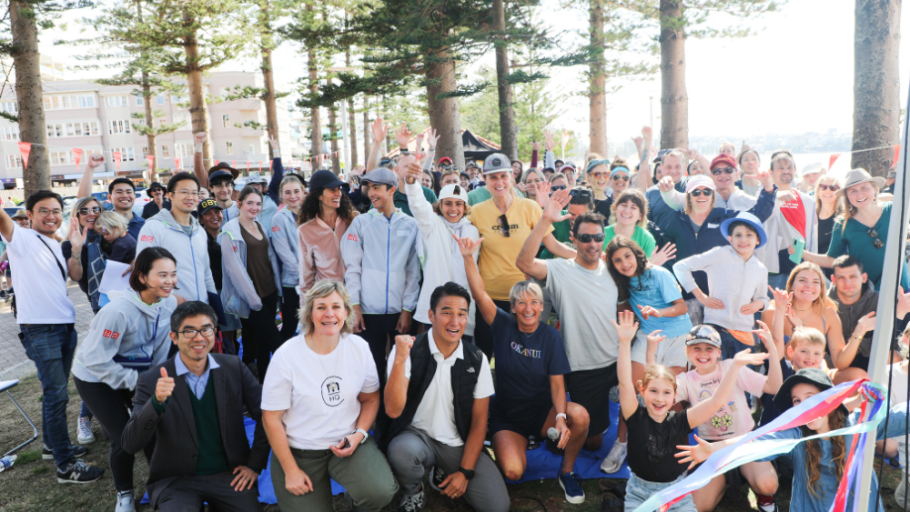 A group of friends laughing while participating in a Manly Beach clean up event