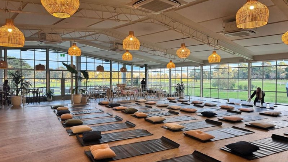People practicing wellness: yoga, breathwork, sound healing, yin pin, acupuncture and energy work, at the Heal'r at Greenfields, Albert Park Lake.