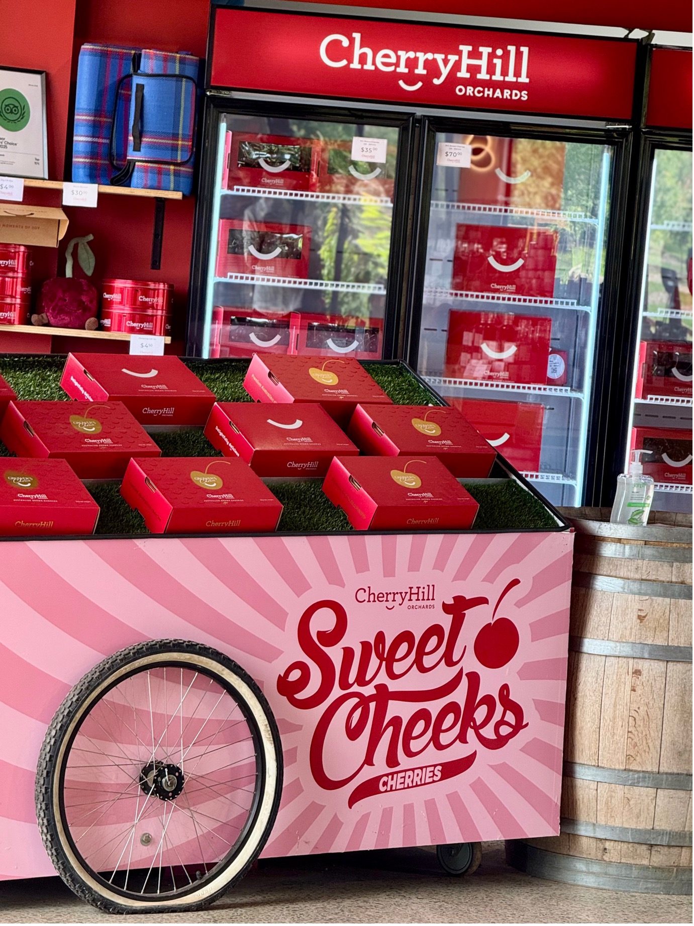 CherryHill Orchards "Sweet Cheeks" cherry gift boxes on display in front of farmgate fridge