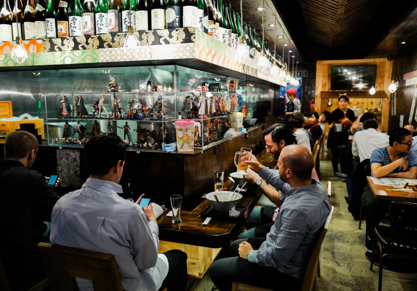dining area of Shujinko Ramen at night, showing bright Lights and late-night ambiance.