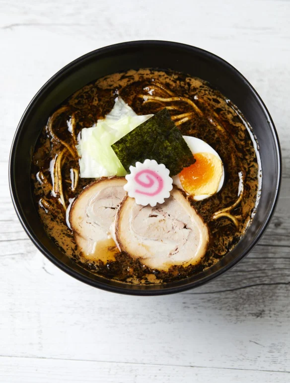 Iconic Kogashi (charred miso) ramen bowl with dark, smoky broth and crispy fried toppings.