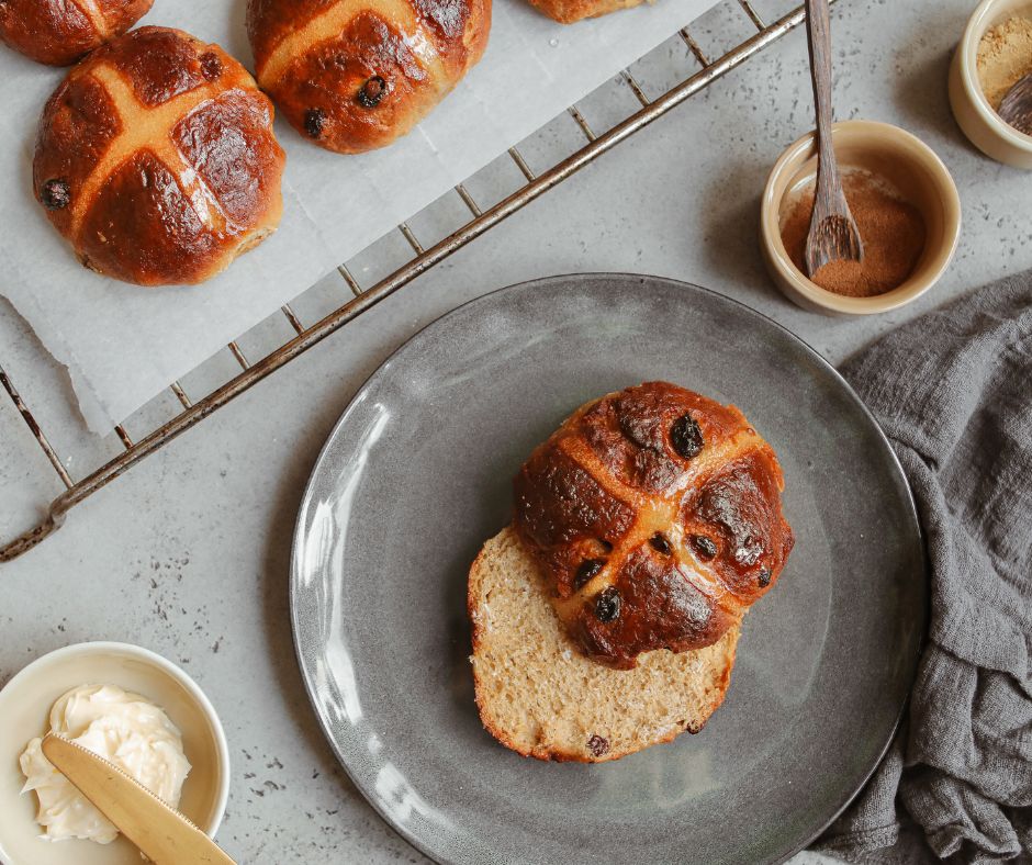 Best hot cross buns Melbourne 2026 freshly baked with glossy glaze on parchment paper