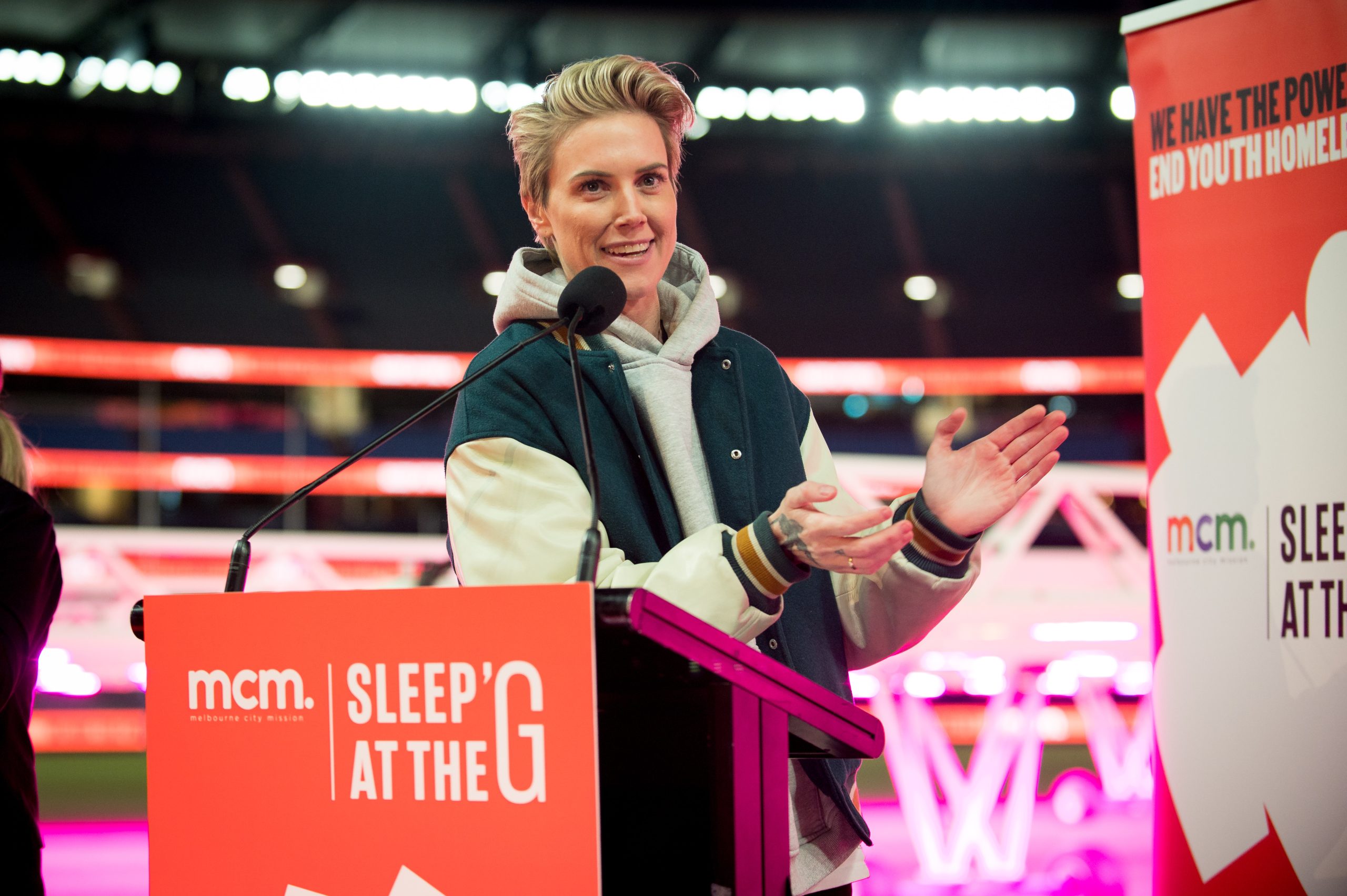 Briohny Dawson MC hosting Sleep at the G 2026 on stage at Melbourne Cricket Ground for Melbourne City Mission youth homelessness fundraiser