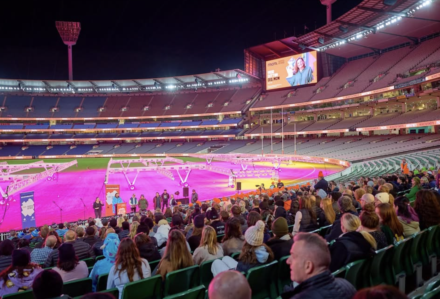 Hundreds of Melbourne participants gathered on the MCG oval during Sleep at the G 2025 youth homelessness fundraiser event at night