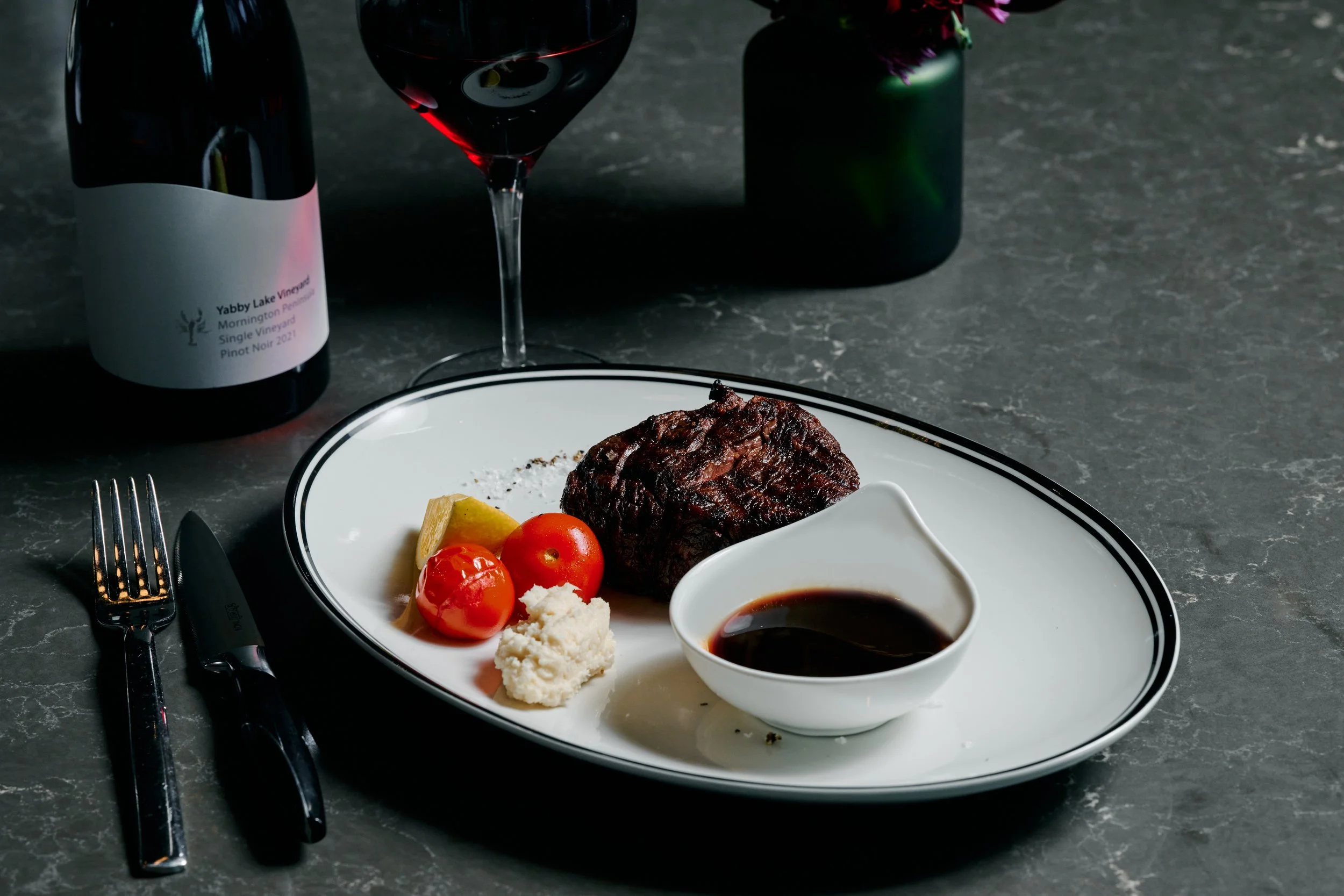 Fire grill steak Melbourne — charred beef fillet with roasted tomatoes and jus at Blacksmith Melbourne