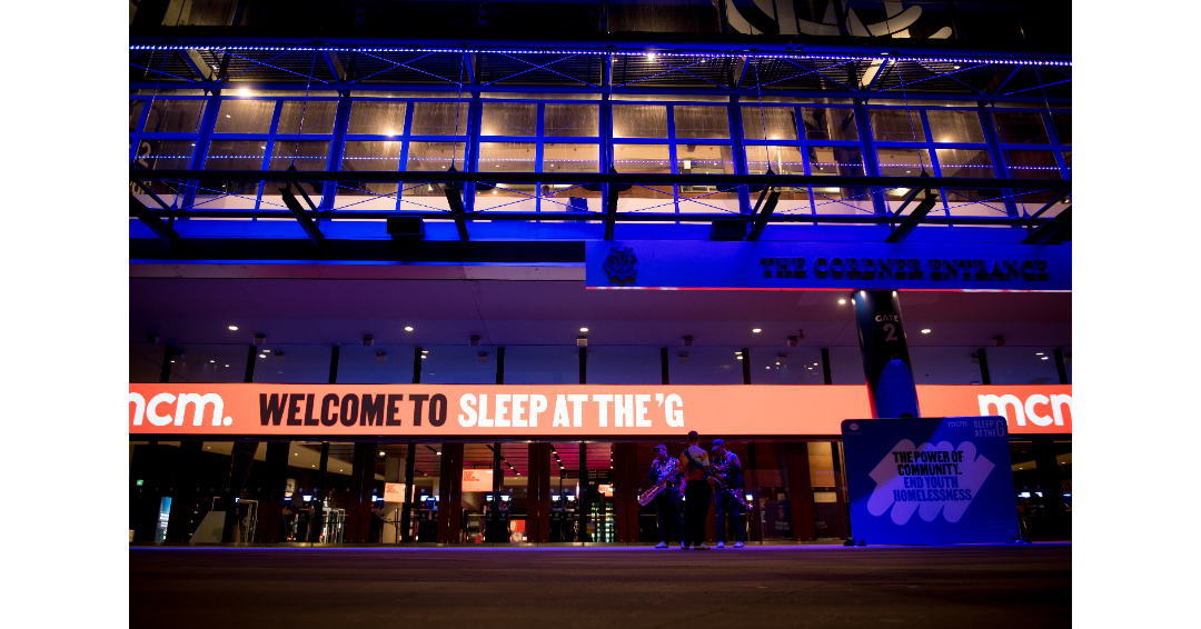MCM Sleep at the G 2026 welcome sign lit up at night on Melbourne Cricket Ground exterior end youth homelessness fundraiser
