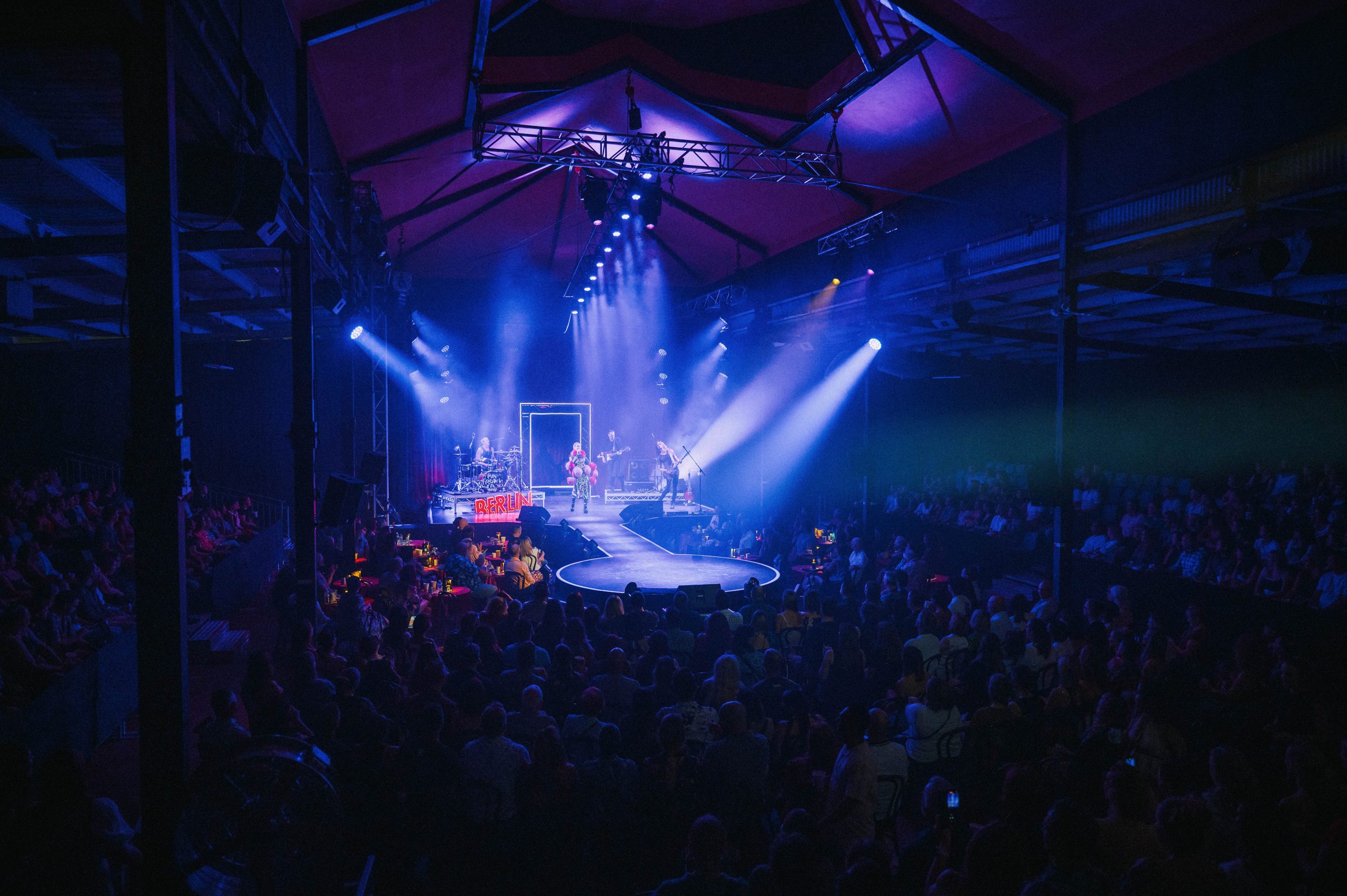 Full venue shot of Club Kabarett at the Meat Market Melbourne with stage lights and packed audience under industrial roof