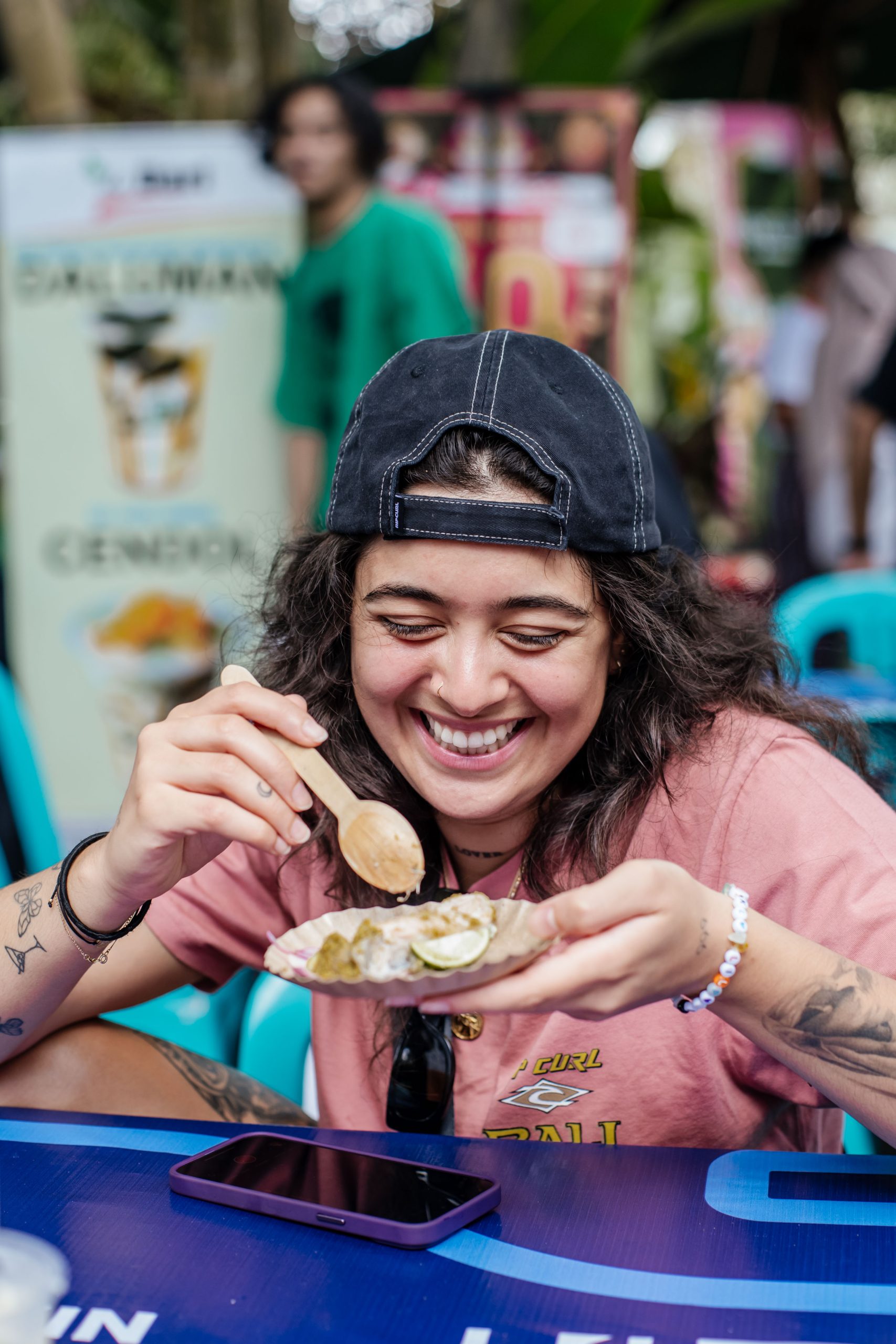 Food lover enjoying street food at Ubud Food Festival 2026 free food market Taman Kuliner Ubud Bali