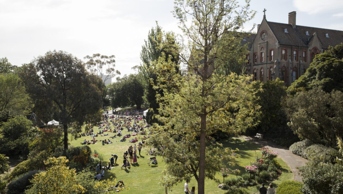 Crowds gathering in the gardens of Abbotsford Convent during Melbourne Design Week 2026 MDW Hub events