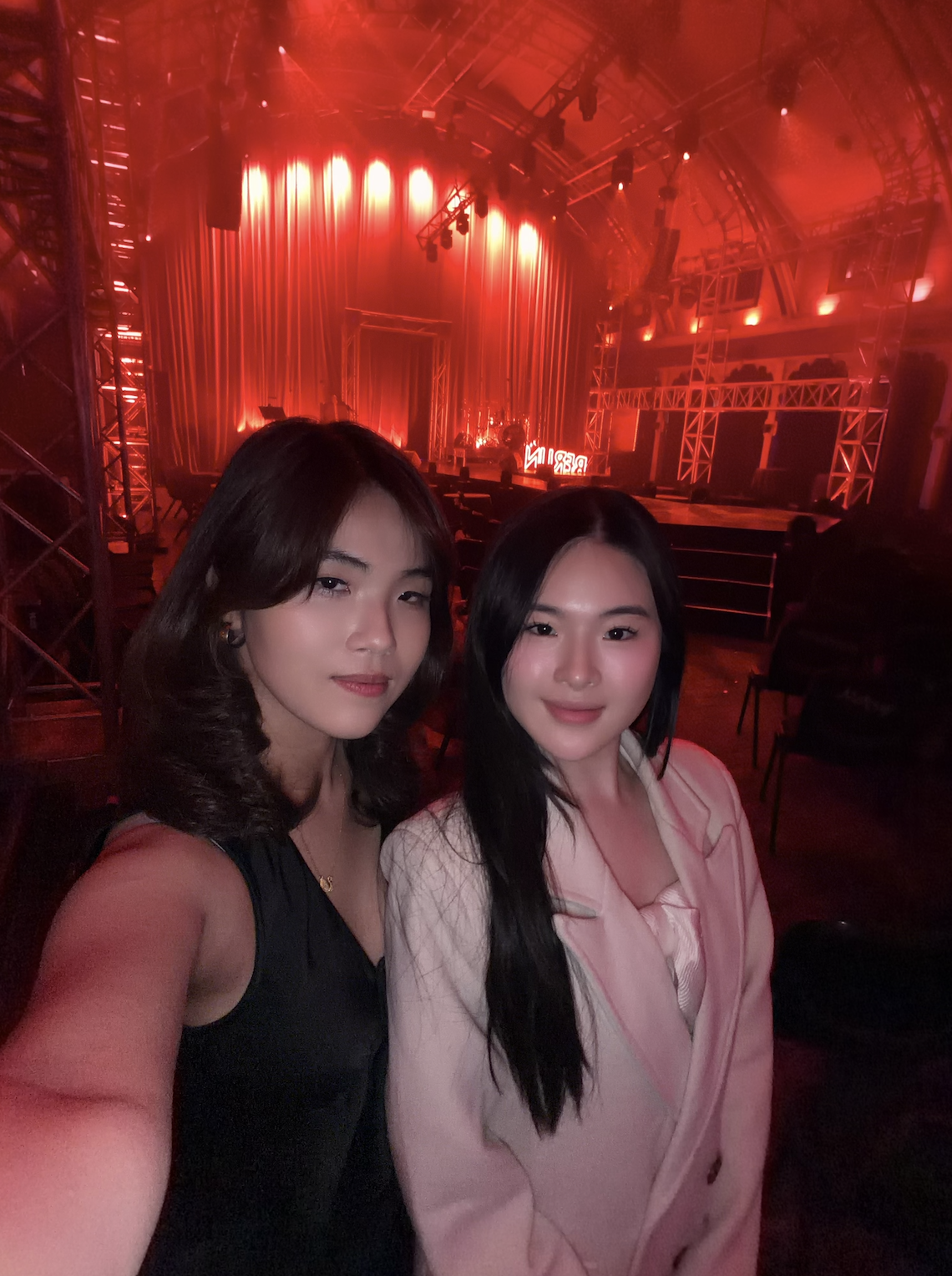 Cherry and Sunny Nguyen taking a selfie inside the Meat Market venue before Club Kabarett Melbourne 2026 with red stage lighting and Berlin neon sign in background