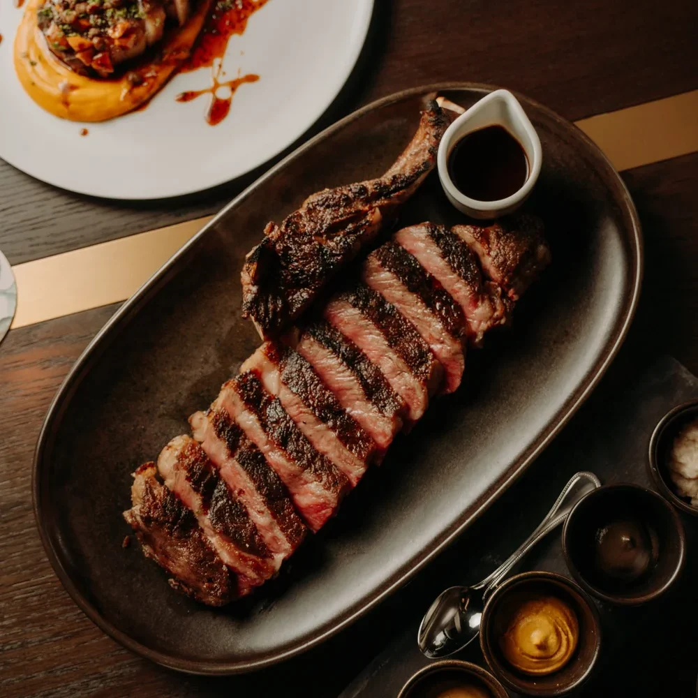 Wood fired steak Melbourne — sliced charcoal ribeye with dipping sauces at Blackbird Bar & Grill Southbank