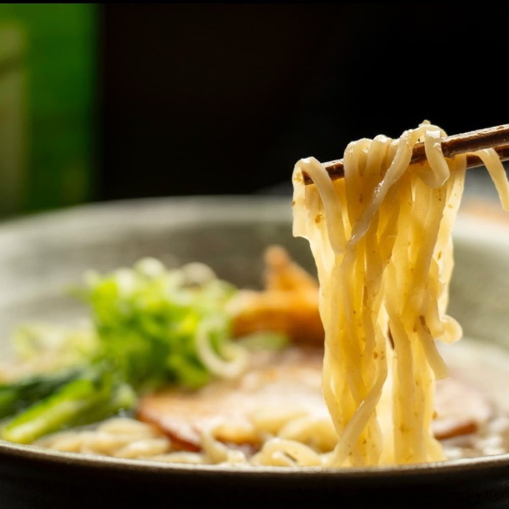 Chopsticks lifting handmade noodles from a bowl of fine-dining Japanese craft ramen at Sara Craft Ramen and Yakitori Bar Melbourne CBD